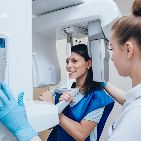 Dental patient getting a CT cone beam scan of her mouth and jaws