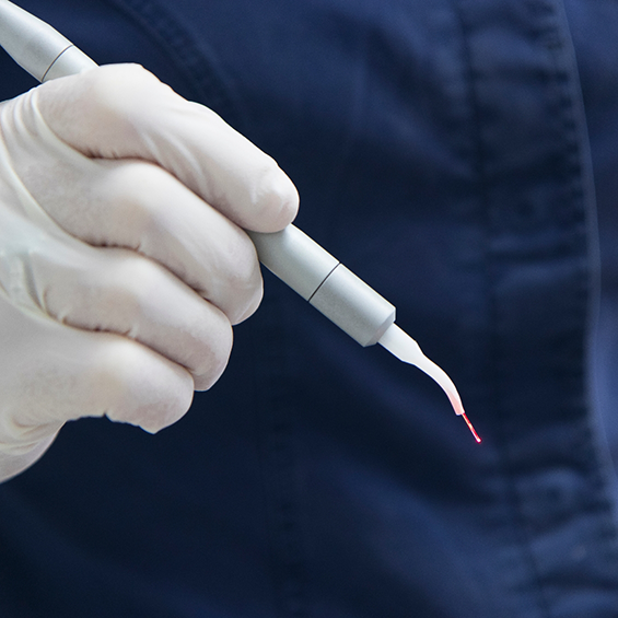 Dentist holding a laser pen