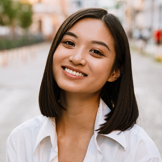 Smiling woman in a white collared blouse