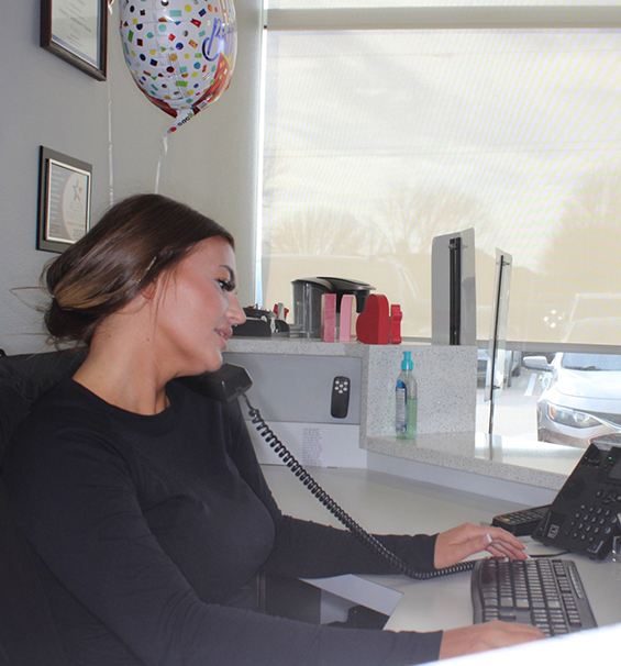 Receptionist talking on the phone with an emergency dental patient
