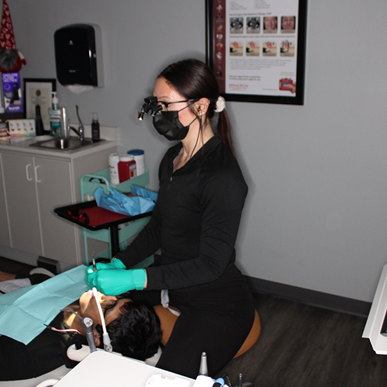 Dental team member looking at a patient's mouth