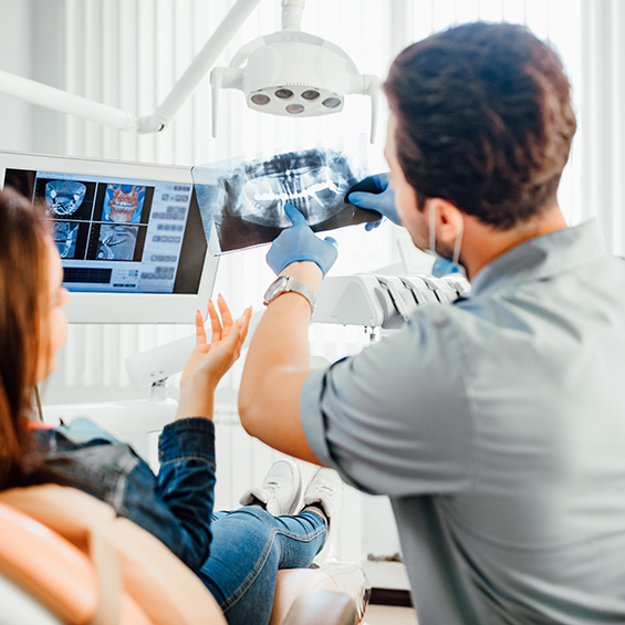Dentist showing a patient an x-ray of their teeth