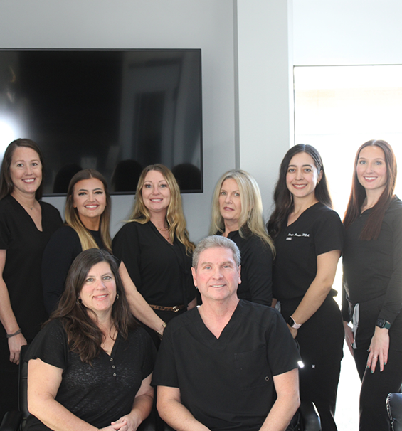 The smiling dentist and team members at Lucas Family Dentistry