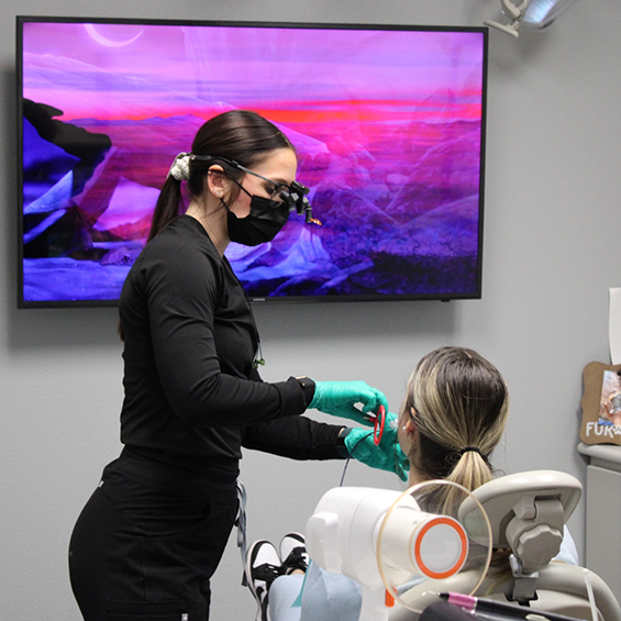 Dental assistant taking x-rays of a patient