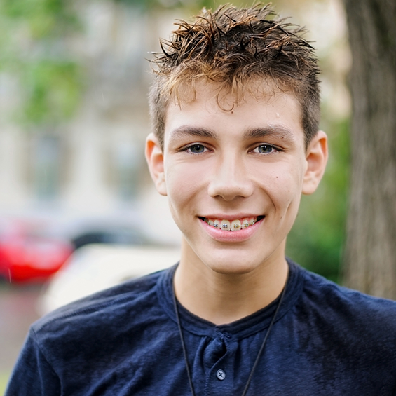 Teenage boy smiling with traditional metal braces