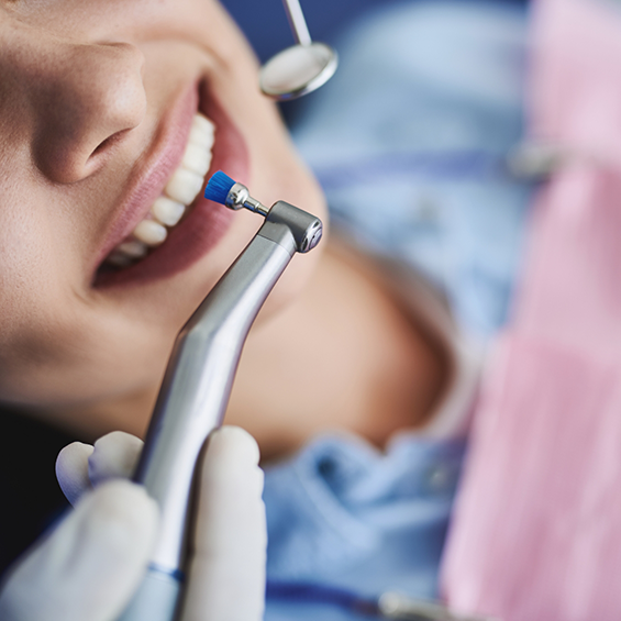 Dental patient having fluoride applied to her teeth