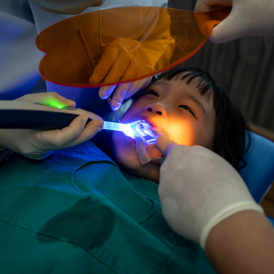 Child getting a dental treatment