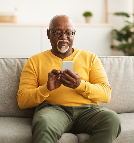 Older man scrolling on his phone