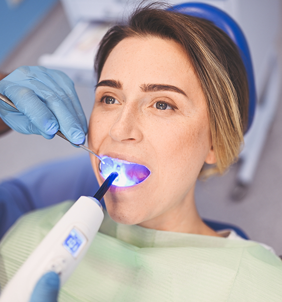 Woman in the dental chair getting a cavity filling