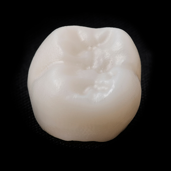 White dental crown on a black background