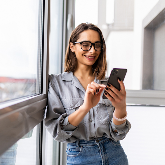 Smiling woman scrolling on her phone