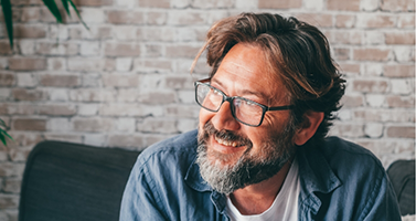 Smiling man in glasses and a denim shirt