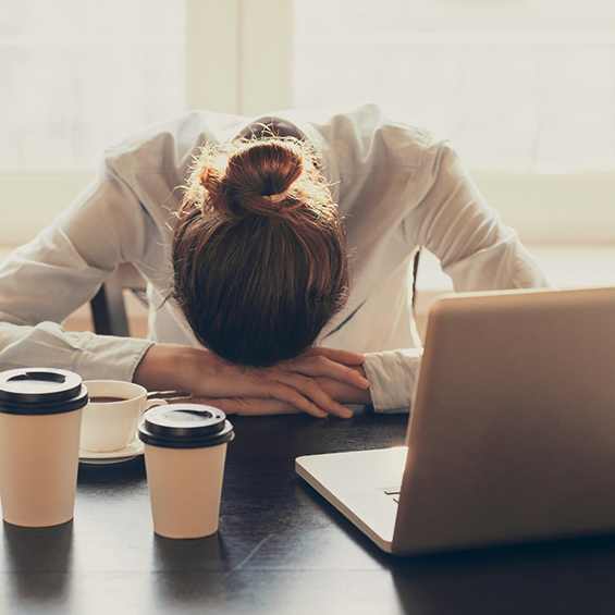 Woman in an office sleeping at her desk
