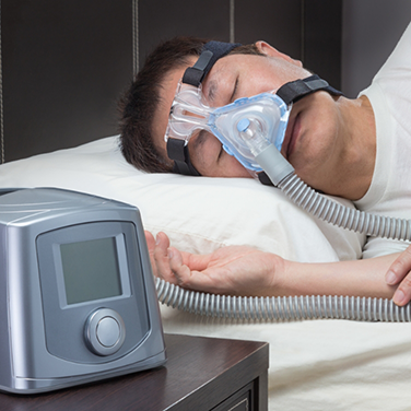 Sleeping man wearing a CPAP mask